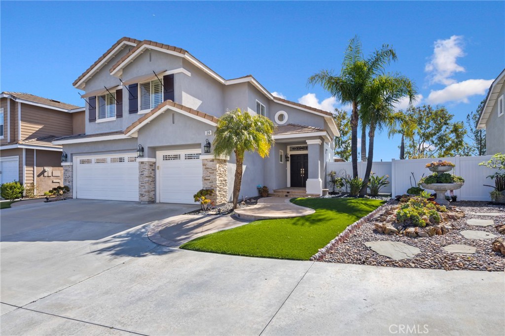 29 Beaulieu Lane Lake Forest, CA 92610 - Photo 4 of 60 a front view of a house with a yard and garage