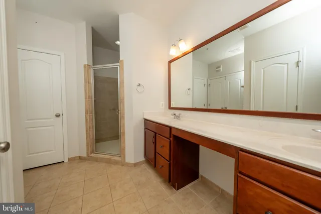 an empty room with a sink and mirror