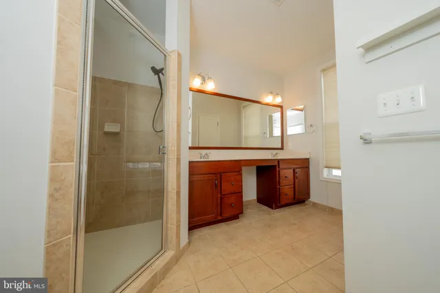 a bathroom with a double vanity sink and mirror