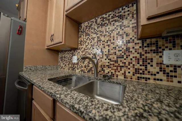 a kitchen with a sink a stove and a microwave oven