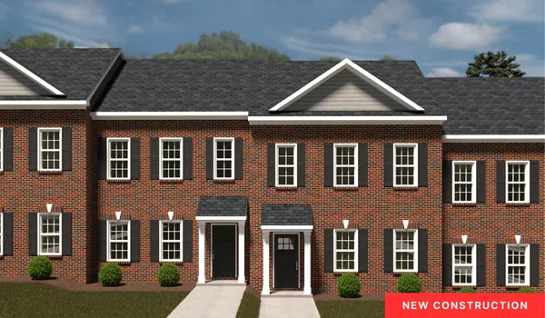 a front view of a residential apartment building with a yard