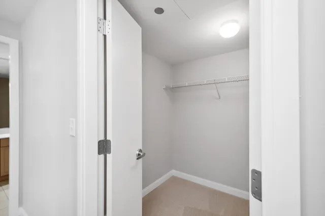 a bedroom with a bed and a potted plant