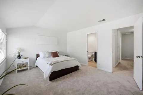a bedroom with a bed and a couch