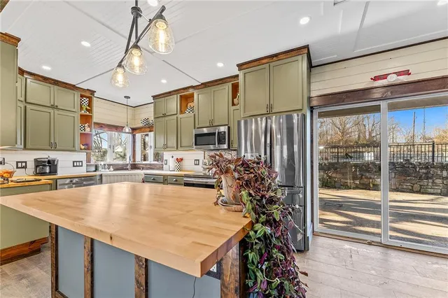 a large kitchen with lots of counter space cabinets and appliances