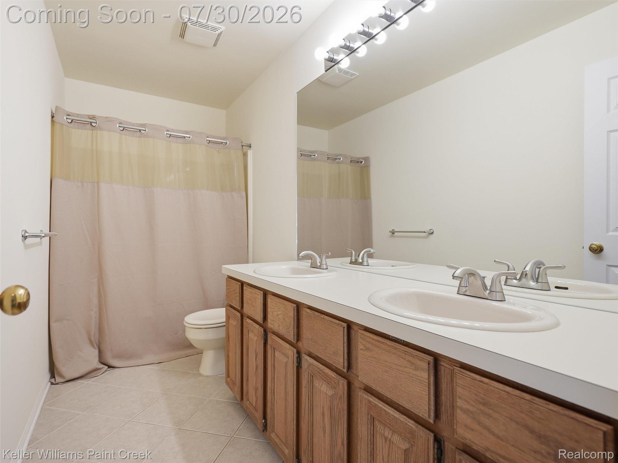 543 Arlington Drive Rochester, MI 48307 - Photo 29 of 59 Double vanity with undermount sinks, chrome faucets, and wood-finish cabinetry