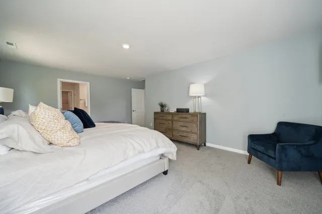 a bedroom with a bed and dresser