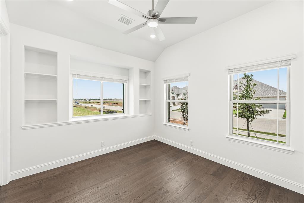 1145 Hitching Post Way Oak Point, TX 75068 - Photo 6 of 39 a view of an empty room with a window and wooden floor