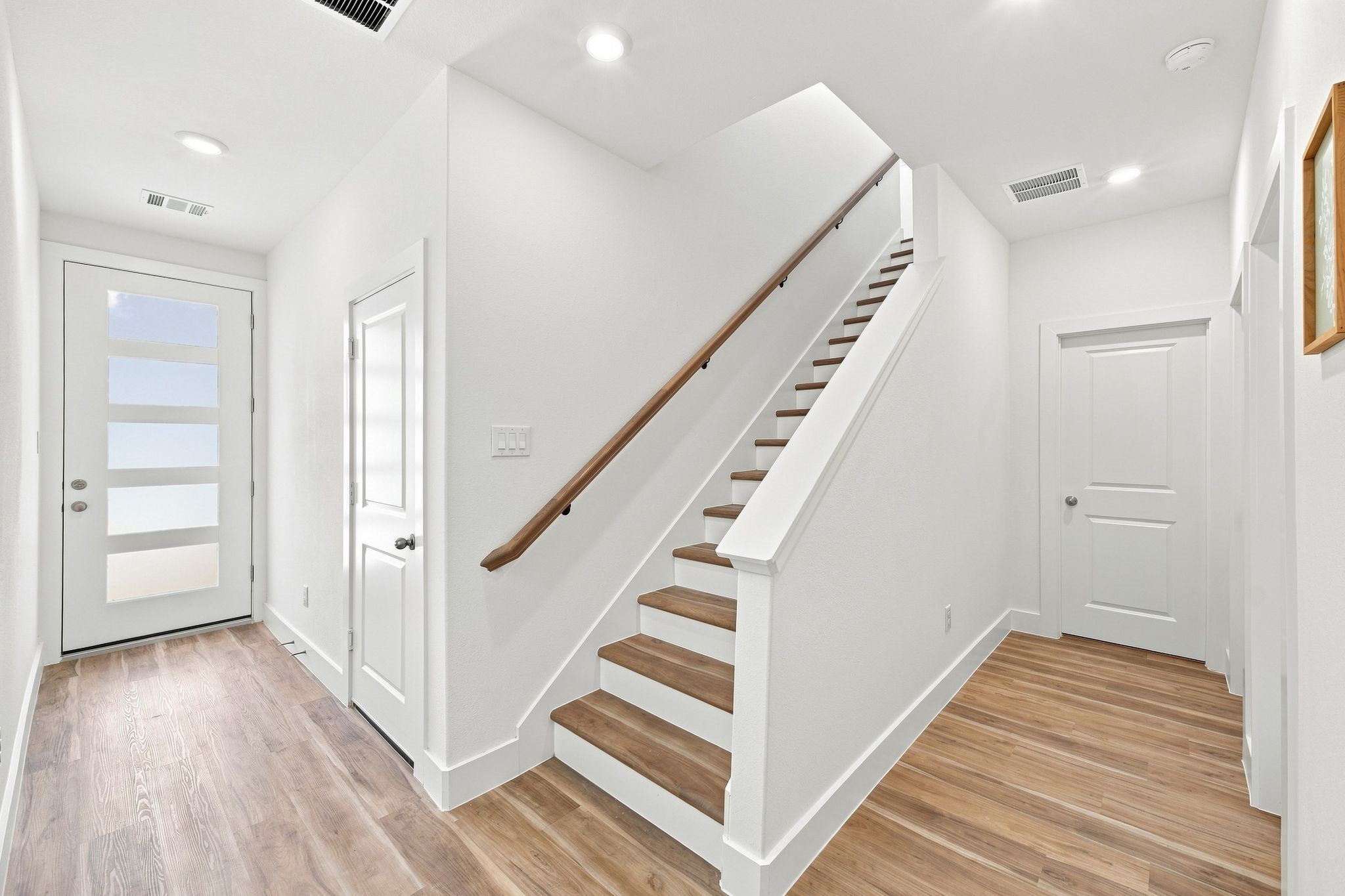 6057 Cebra Street Houston, TX 77091 - Photo 15 of 42 Beautiful wood staircase with an open design connecting the home's living spaces. Photos are from a different property with a similar floor plan. Finishes, features, and orientation may vary.