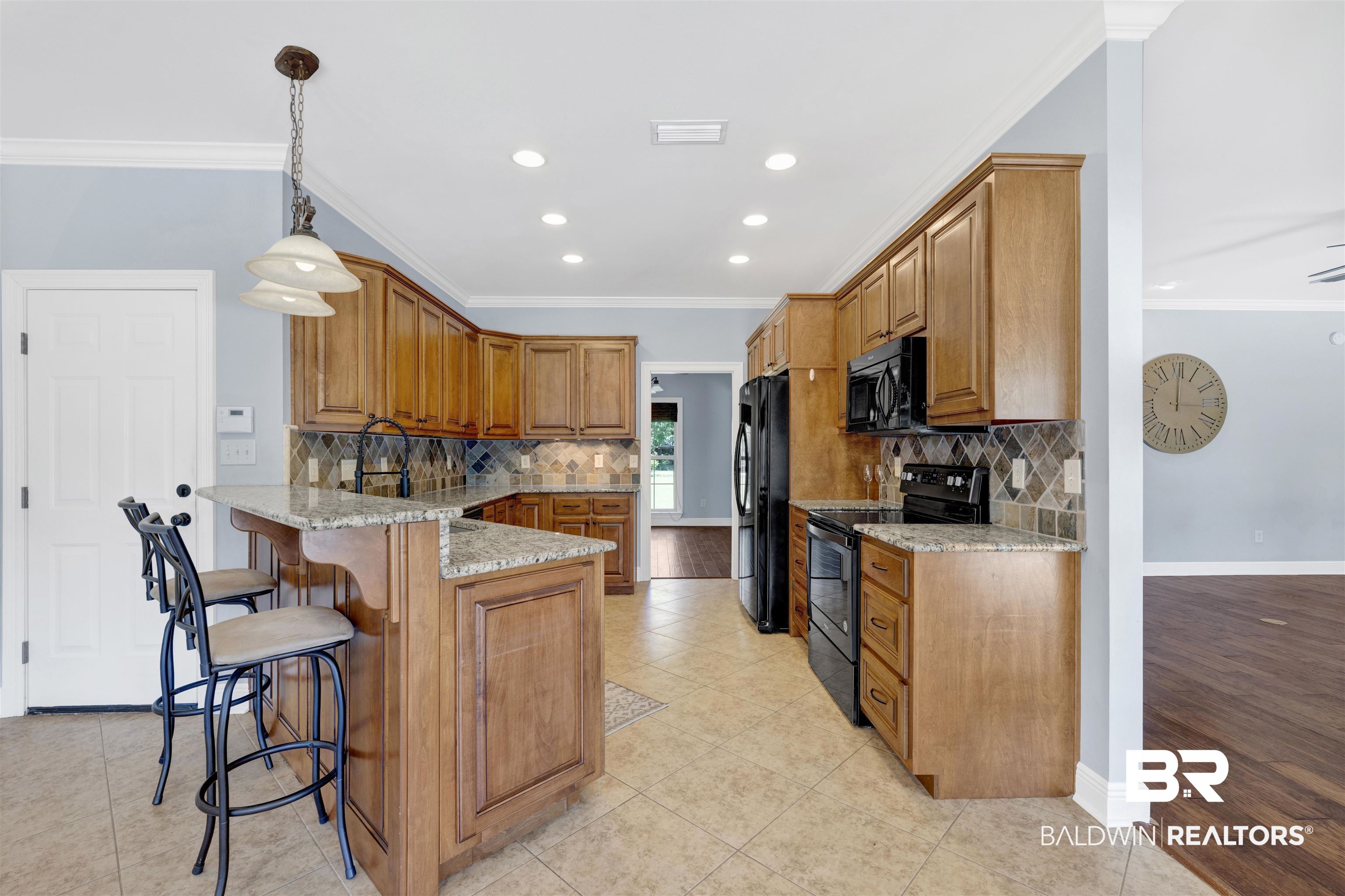 12944 Anna's Way Stapleton, AL 36578 - Photo 41 of 64 Kitchen featuring wood cabinetry, granite countertops, tile flooring, and black appliances
