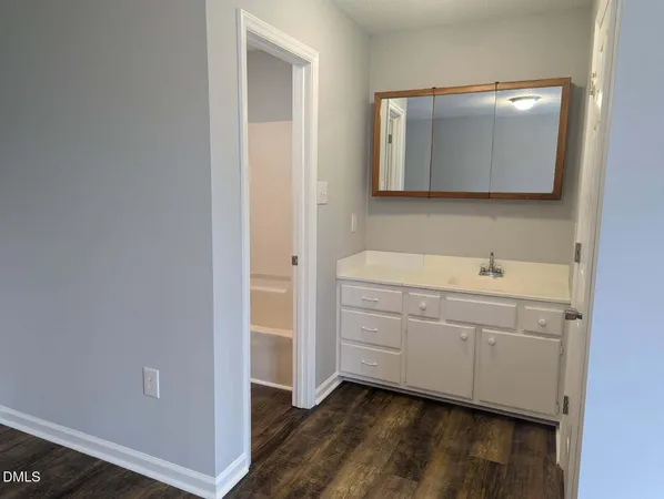 a room with a sink and a mirror