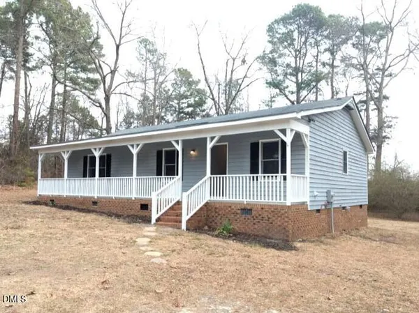 a view of a house with a yard covered in snow