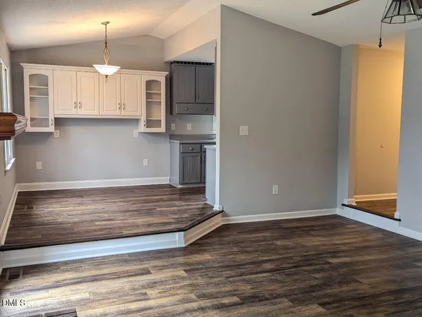 a view of a kitchen with wooden floor and a sink