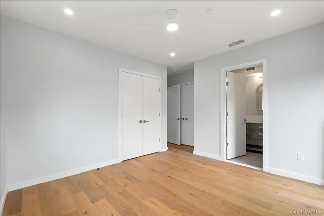 an empty room with closet and a bathroom