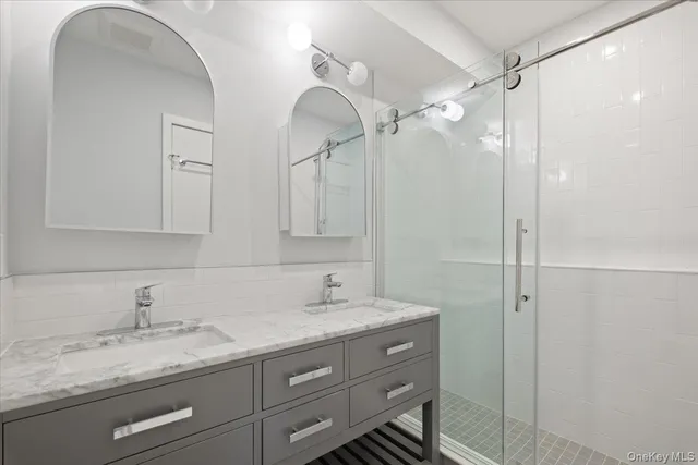 a bathroom with a granite countertop sink mirror and double
