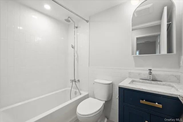a bathroom with a sink a toilet and a bathtub