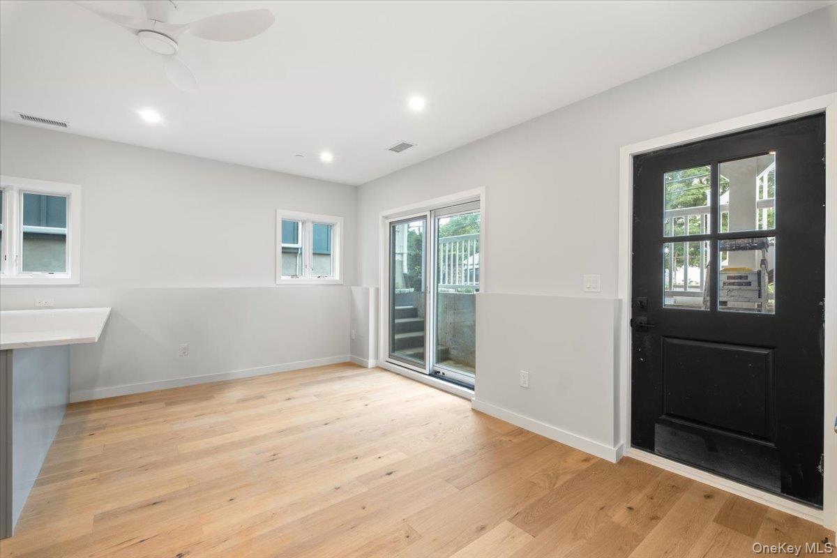 46 Hudson Street, Unit 1 Sleepy Hollow, NY 10591 - Photo 2 of 31 a view of an empty room with wooden floor and a window