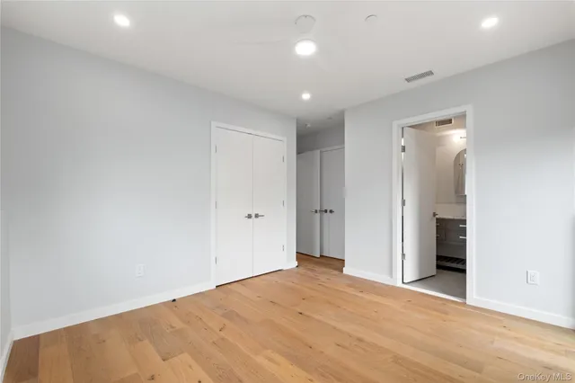 an empty room with closet and a bathroom