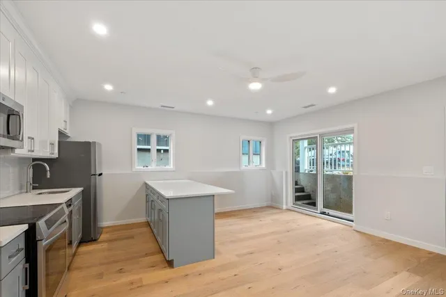 a kitchen with cabinets and wooden floor