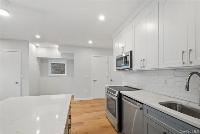a kitchen with stainless steel appliances granite countertop a sink and cabinets