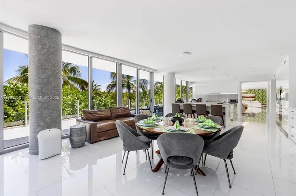 a dining room with furniture window and outdoor view