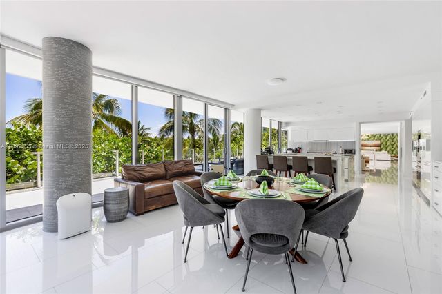 a dining room with furniture window and outdoor view