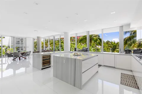 a large white kitchen with a large window