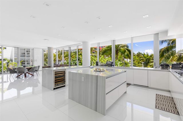 a large white kitchen with a large window