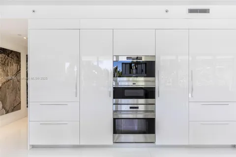 a kitchen with stainless steel appliances a refrigerator and a stove