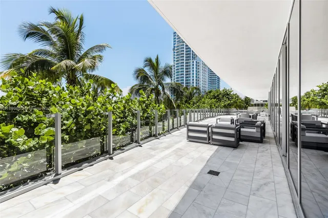 a view of a terrace with couches and potted plants