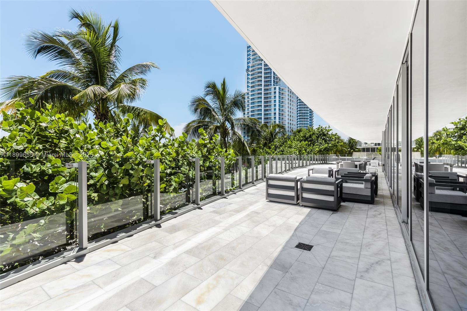 1 Collins Avenue, Unit 207 Miami Beach, FL 33139 - Photo 23 of 44 a view of a terrace with couches and potted plants