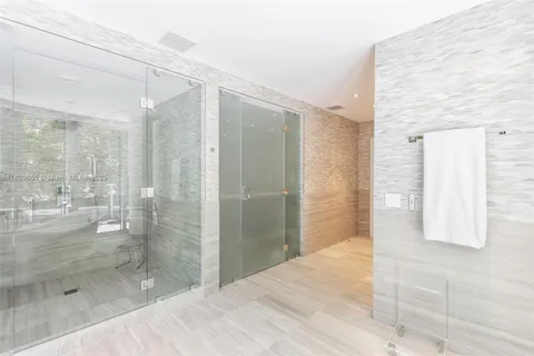 a bathroom with a glass shower door