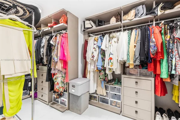 a bedroom with a bed next to a large window