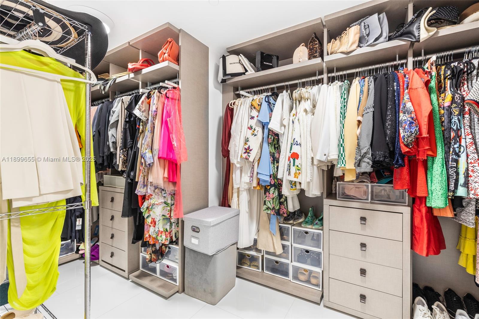 1 Collins Avenue, Unit 207 Miami Beach, FL 33139 - Photo 38 of 44 a view of walk in closet with clothes and shoes