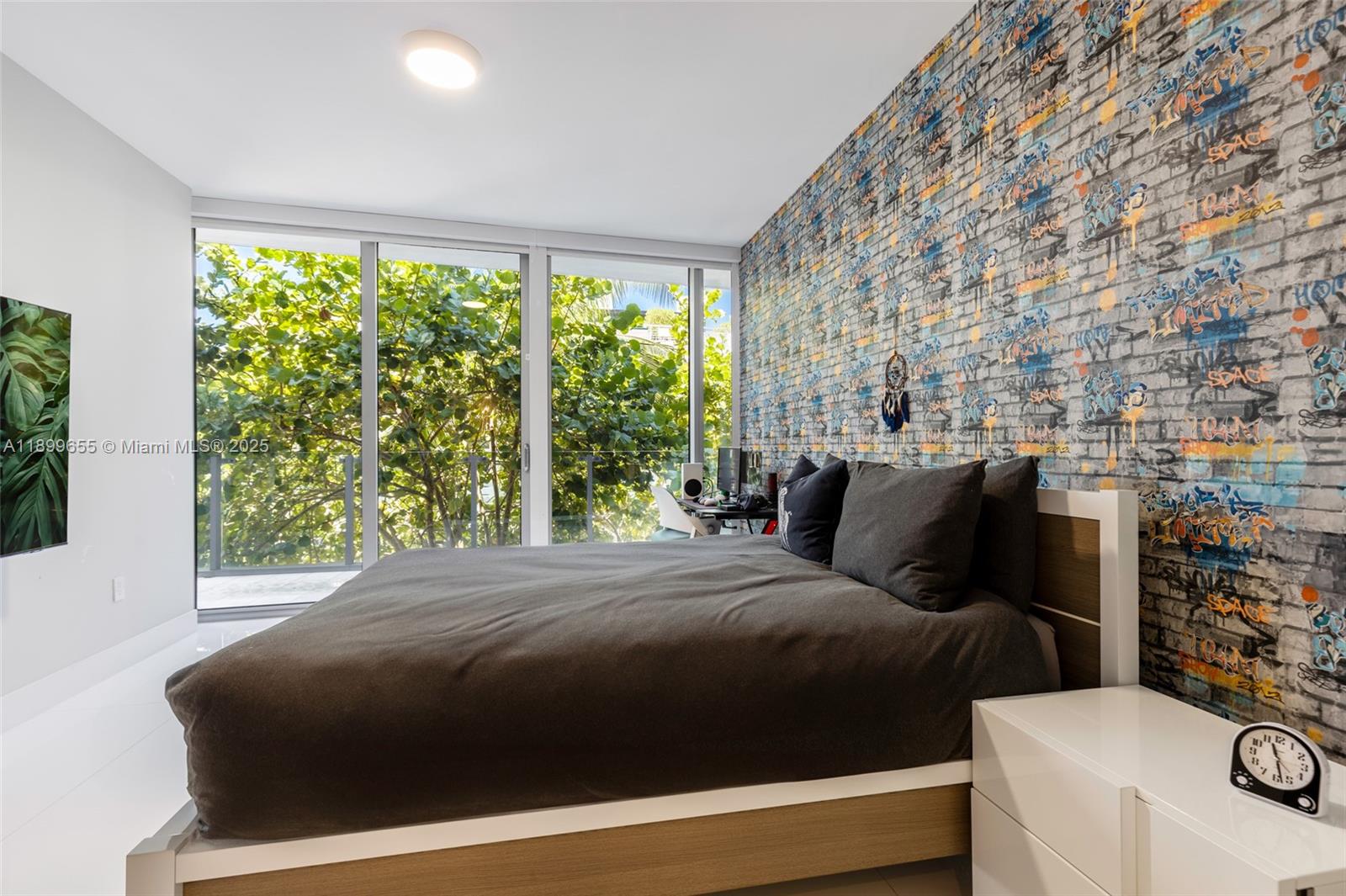 1 Collins Avenue, Unit 207 Miami Beach, FL 33139 - Photo 39 of 44 a bedroom with a bed next to a large window