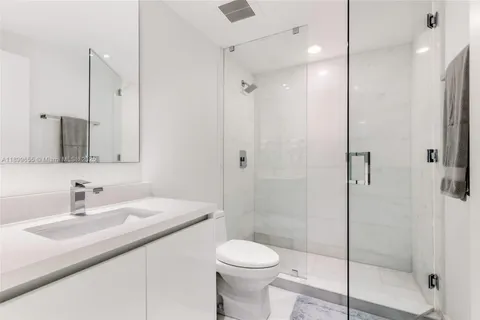 a bathroom with a double vanity sink and mirror