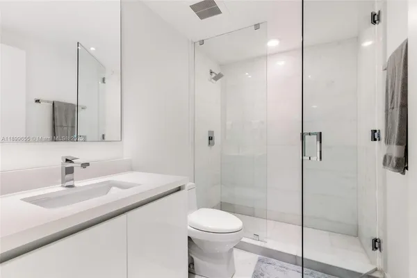 a bathroom with a double vanity sink and mirror