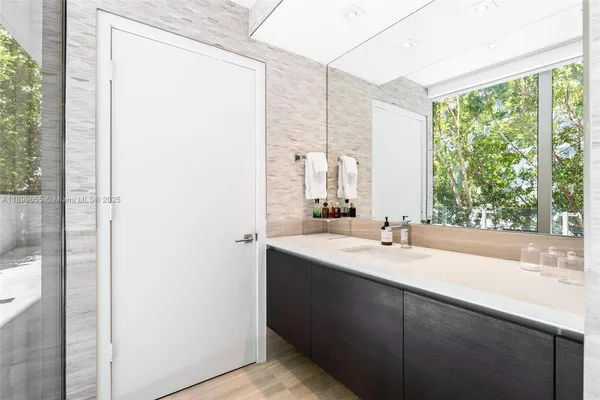 a living room with a couch and a potted plant