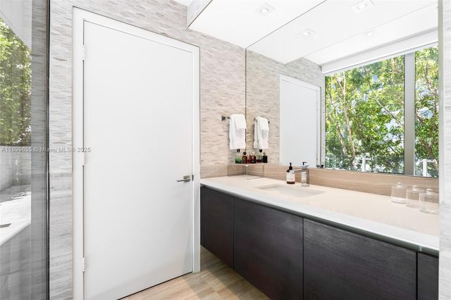 a living room with a couch and a potted plant