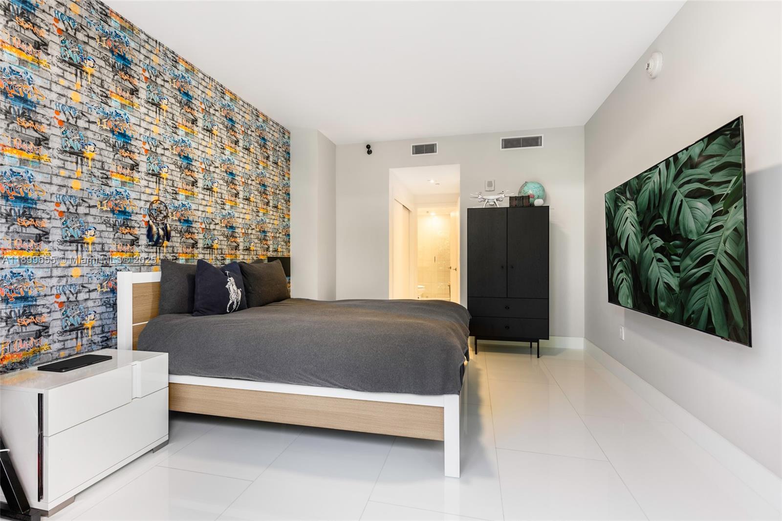 1 Collins Avenue, Unit 207 Miami Beach, FL 33139 - Photo 42 of 44 a living room with a couch and a potted plant