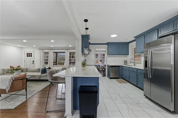 a large kitchen with a large counter top appliances and cabinets