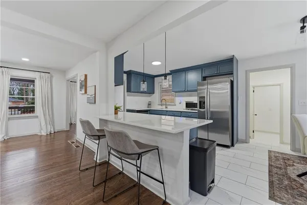 a kitchen with kitchen island a sink counter top space and stainless steel appliances