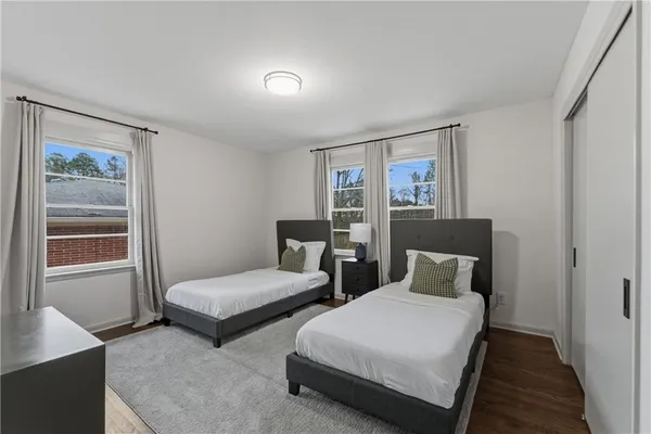 a bedroom with two beds and a window