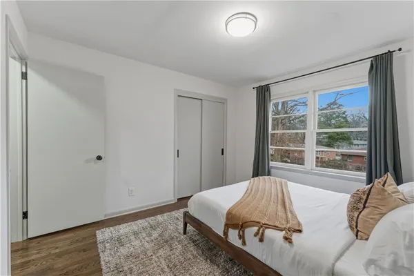 a bed sitting in a bedroom next to a window
