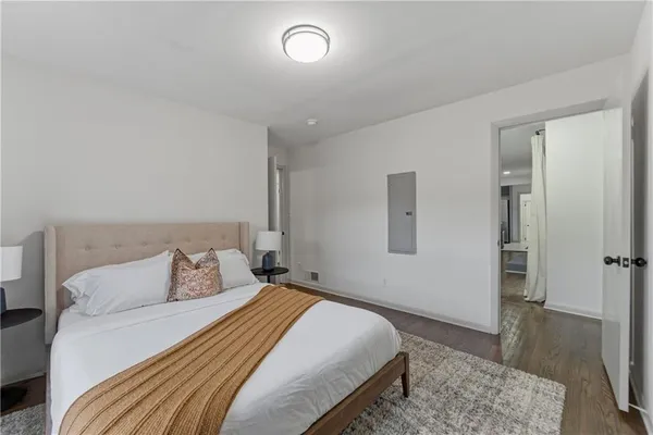 a bedroom with a bed and wooden floor