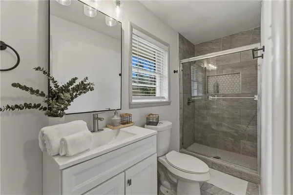 a bathroom with a sink toilet and shower
