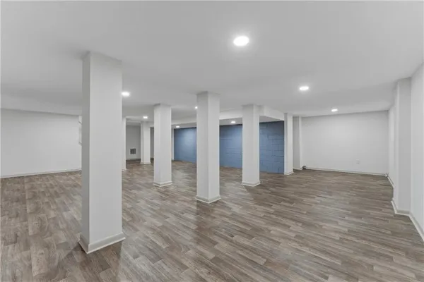 a view of empty room with wooden floor and fireplace