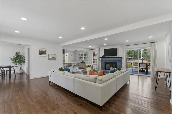 a living room with fireplace furniture and a wooden floor