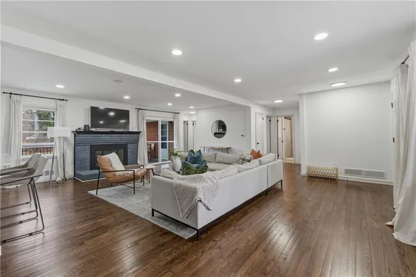 a living room with furniture wooden floor and a fireplace