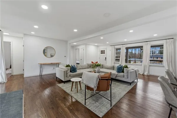 a living room with furniture and wooden floor