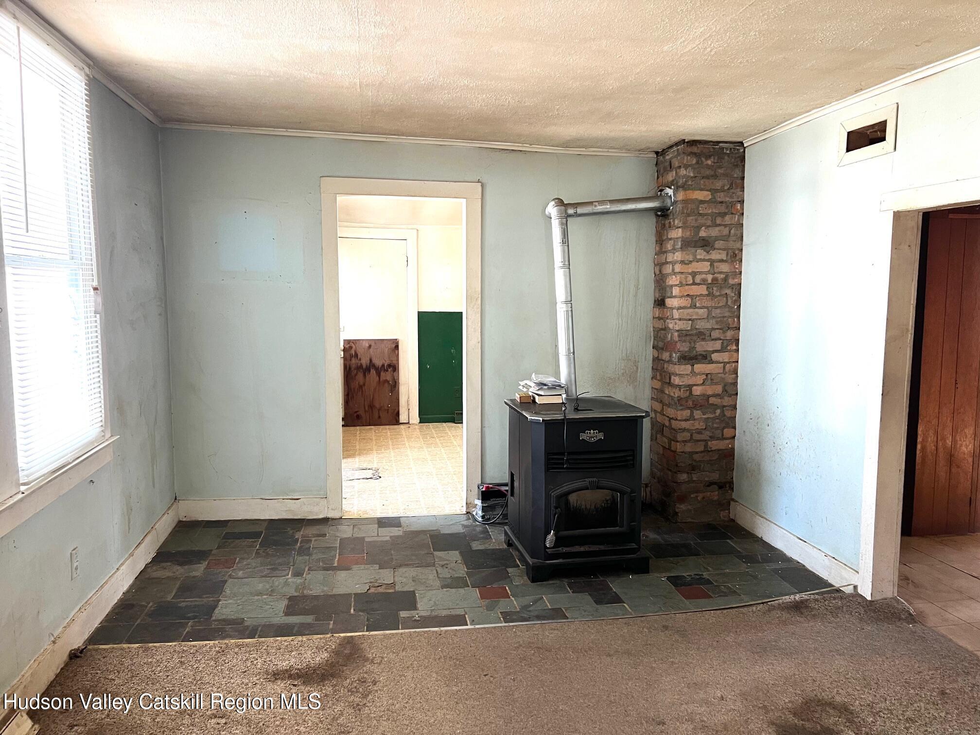 156 Co Rte 10 Germantown, NY 12526 - Photo 3 of 8 a view of an empty room with a fireplace and a window
